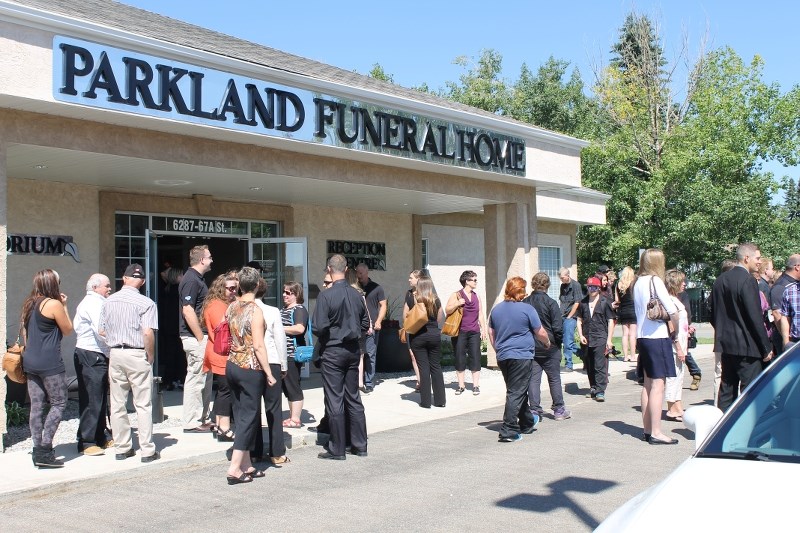 Friends gather outside Red Deer&#8217;s Parkland Funeral Home last Sunday after honouring the life of Christopher Lawrence.