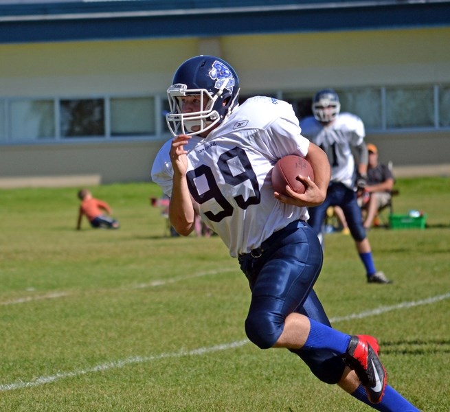 Innisfail&#8217;s Darian Davis springt to a 48-year pass and run touchdown in the dying seconds of the third quarter during the Cyclones&#8217; game on Sept. 6 against the