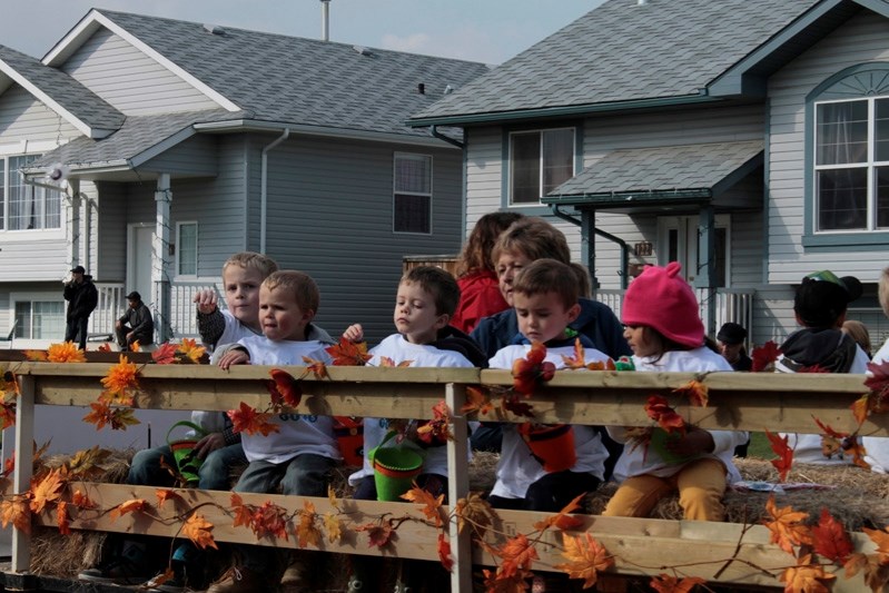 Penhold community T.I.E.S. children throw candy during the 2014 Fall Festival parade.