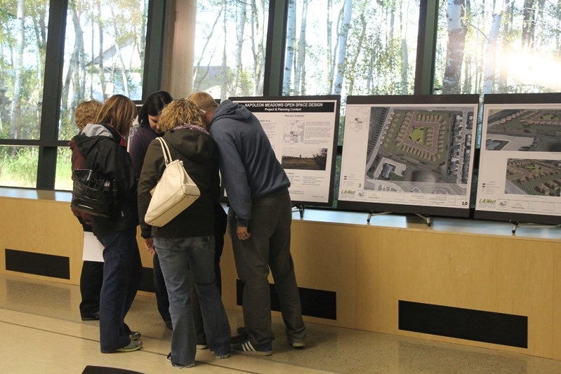 Innisfailians discuss the Napoleon Meadows open space concept plans among themselves at the open house on Oct. 2 held at the Library Learning Centre.