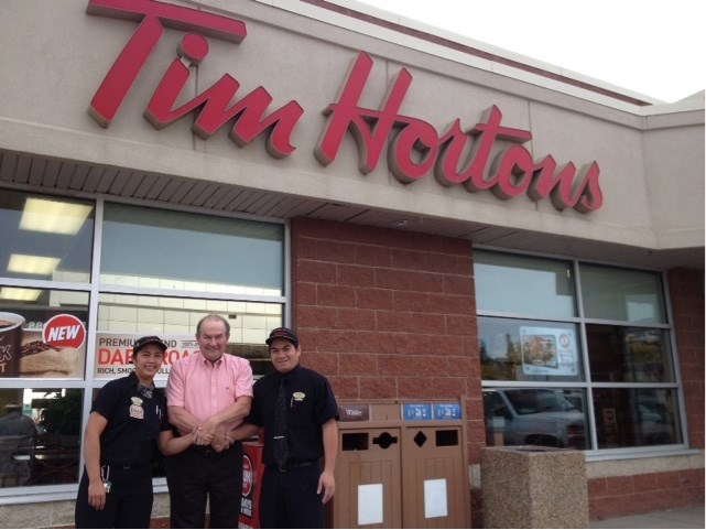 Tim Hortons manager Christine Pasiliao and assistant manager Alex Alcantra tie Big Brothers &#038; Big Sisters of Innisfail executive director Tim Howard in knots as