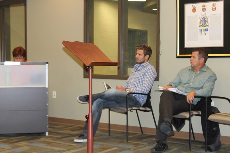 Steve Bontje (left) and Gord Smith of Laebon Developments listen while Penhold Council debates their subdivision request to create Palisades.