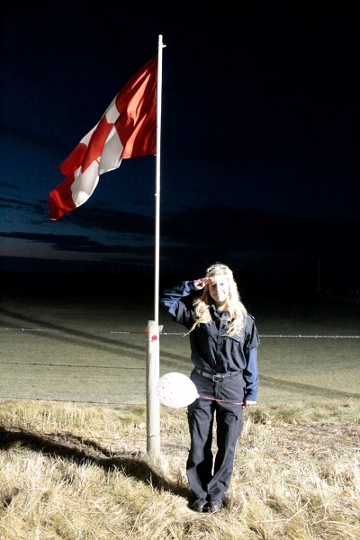 Penhold firefighter Tatyanna Murray salutes the 116,000 fallen Canadian soldiers in a sunrise ceremony held on Highway 11 on Oct. 29.