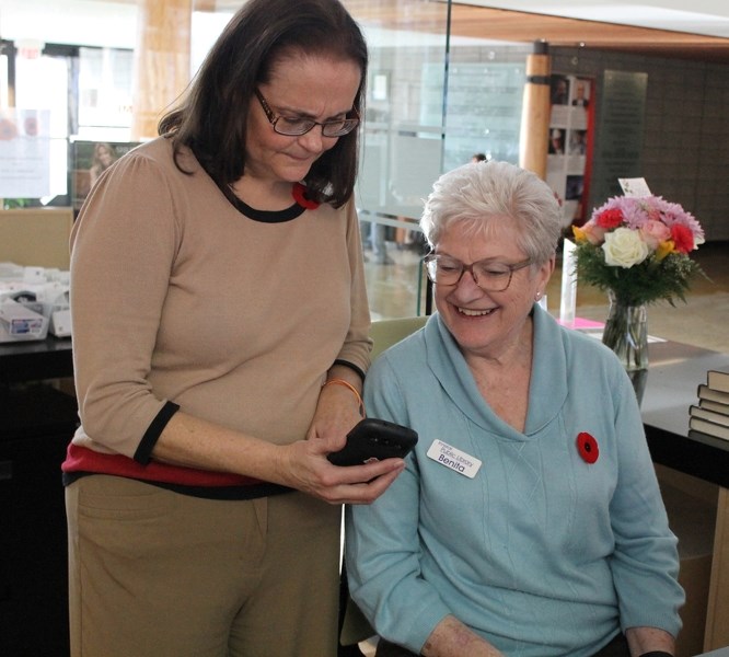 Laurie Hodges Humble, manager of the library (left), and Benita Dalton were forced to call out of the Innisfail Library/Learning Centre with their cellphones during the TELUS 