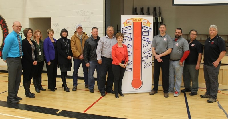 Erin Flewelling (second from left) and playground partners poses with the fundraising meter after cheque presentations at école John Wilson on Dec. 5.