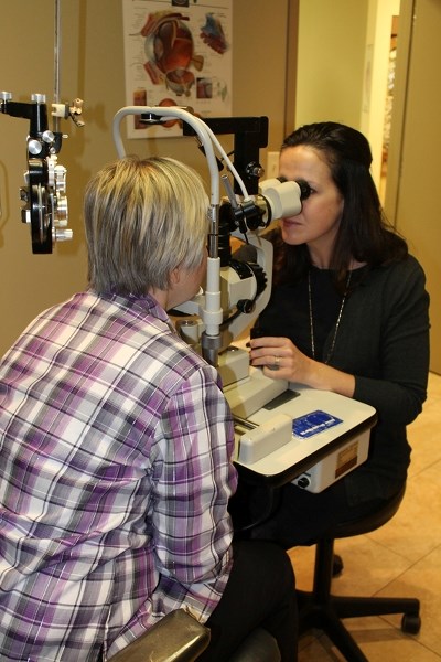 Dr. Amy Forrest examines a patient for diabetes-related optical damage in her Innisfail office.