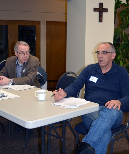 Close to a dozen citizens came together on Jan. 15 at the Peace Lutheran Church, to discuss bringing a second Syrian refugee family to Innisfail. Kevin Dorma, left, and Bud