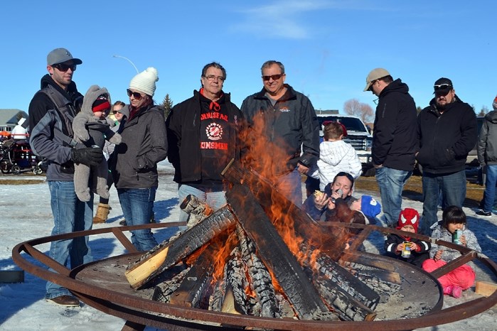 Many citizens enjoyed chatting around the firepit, including the Innisfail Kinsmen&#8217;s Al Brown (centre-left) and Mayor Brian Spiller.