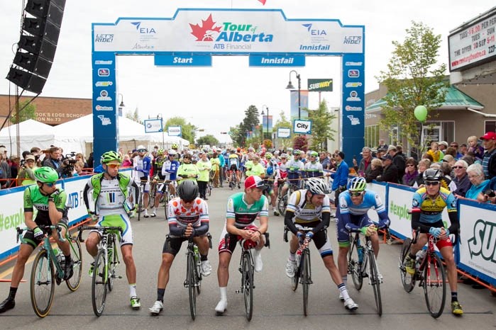 Riders share a light moment just before starting from Innisfail during the 2014 Tour of Alberta.