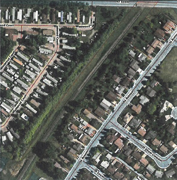 The reconstruction of the 1,400-metre northeast trunk main will go through the outside of the Westwood Court Mobile Home Park (left) along a 350-metre stretch of trees.