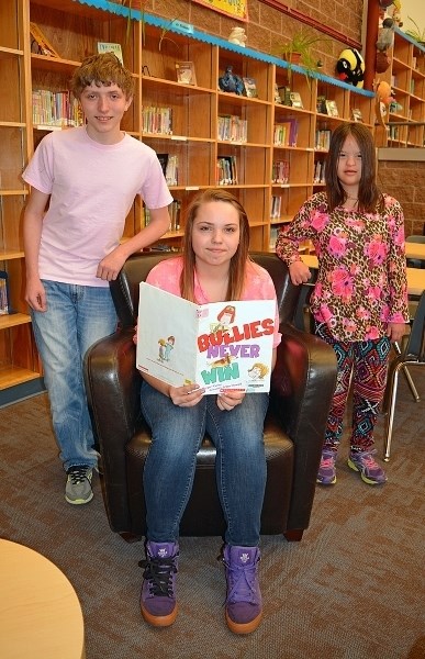 Students at Innisfail Middle School showed their support to stop bullying by wearing the colour pink on Pink Shirt Day on Feb. 24. From left are Grade 8 students Connor