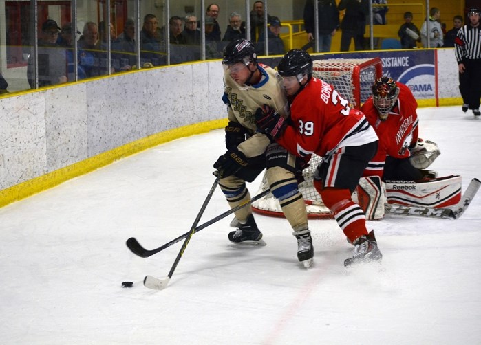 Game 5 hero Mark Bomersback battles for the puck in front of the Eagles net during first period action Sunday in Lacombe. Bomersback scored two goals, including the 3-2 game