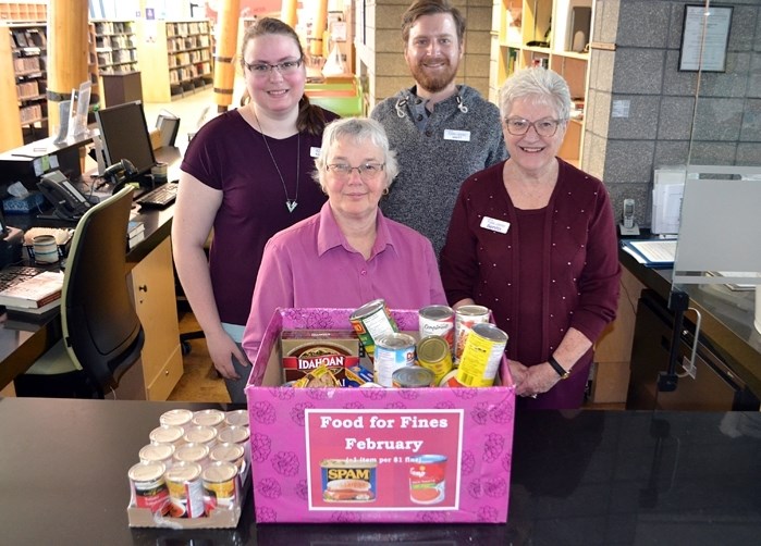 Library staff will continue its Food for Fines program in March. From left to right in front is Sherry Driezen and Benita Dalton. In back is Michelle Harder and library