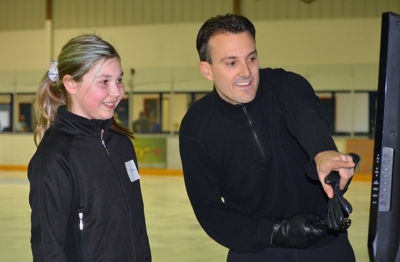 Ben Ferreira, right, reviews an Axel jump with Innisfail skater Devan Korsiger during an Axel Master Class workshop in Innisfail on March 5.