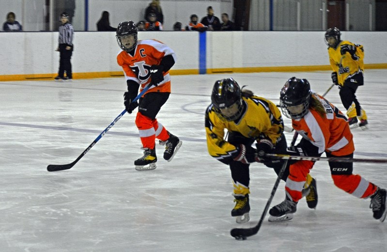 The Innisfail Female Atom Flyers battle for the puck against the Olds Grizzlys during third period action in the semifinal game of the 2016 ATB Financial Provincial