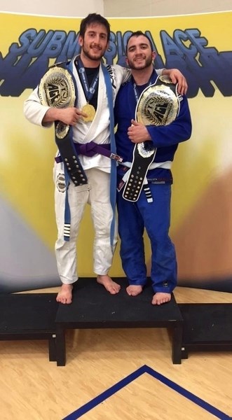 Brothers Logan, left, and Conor Bruneau proudly display their championship belts they recently won in the Submission Ace Championship in Blackfalds on Feb. 27.