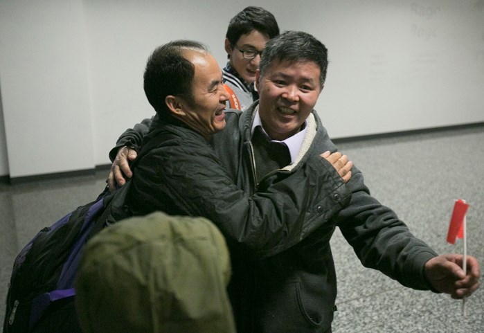 Joseph Shi, right, a political refugee who escaped to Canada in 2000 to live and prosper in Central Alberta, hugs his brother Fukui Shi, who was finally able to embrace