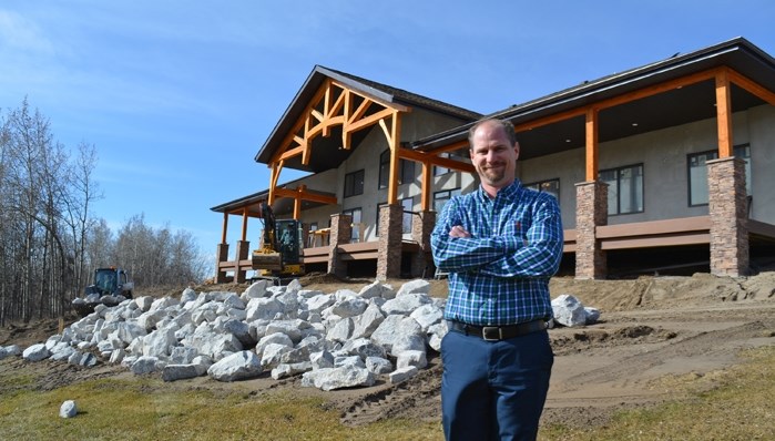 Darren Black, manager of the Innisfail Golf Club, stands in front of the new clubhouse currently under construction. The new facility will include a larger dining area, an