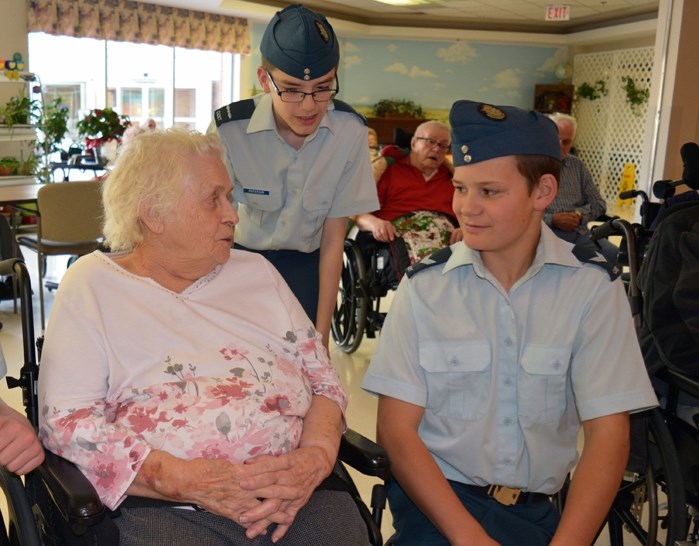 Lillian Smitheman, left, speaks with cadets LAC Damen Patterson, back, and Cpl. Joe Cuff, right, from the 7 Penhold Royal Air Cadet Squadron during a visit to the Rosefield