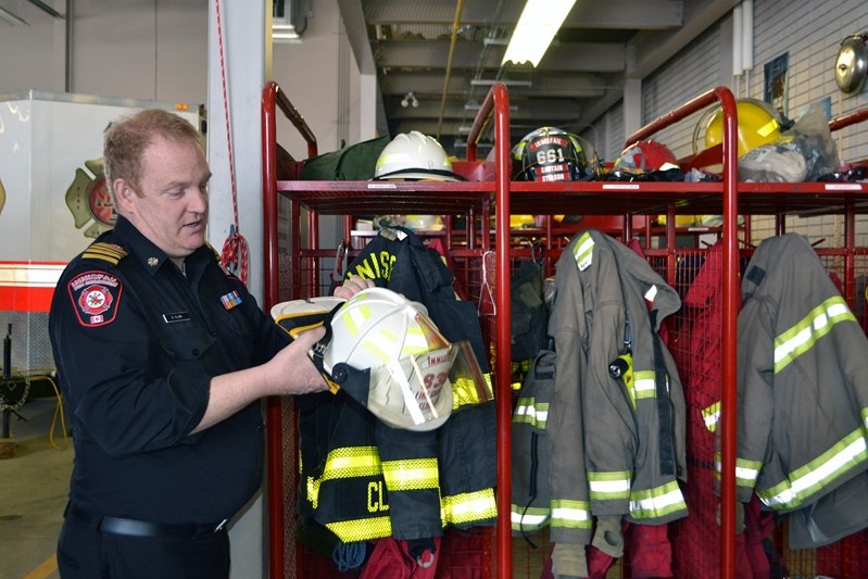 Dean Clark, chief of the Innisfail Fire Department, prepares his gear in case he and other local firefighters are called to help out in the huge fire in Fort McMurray.