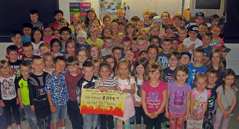 Students at Chinook Center School celebrate their fundraising effort for Fort McMurray on May 19 by collecting $1,194.25 for the wildfire evacuees.