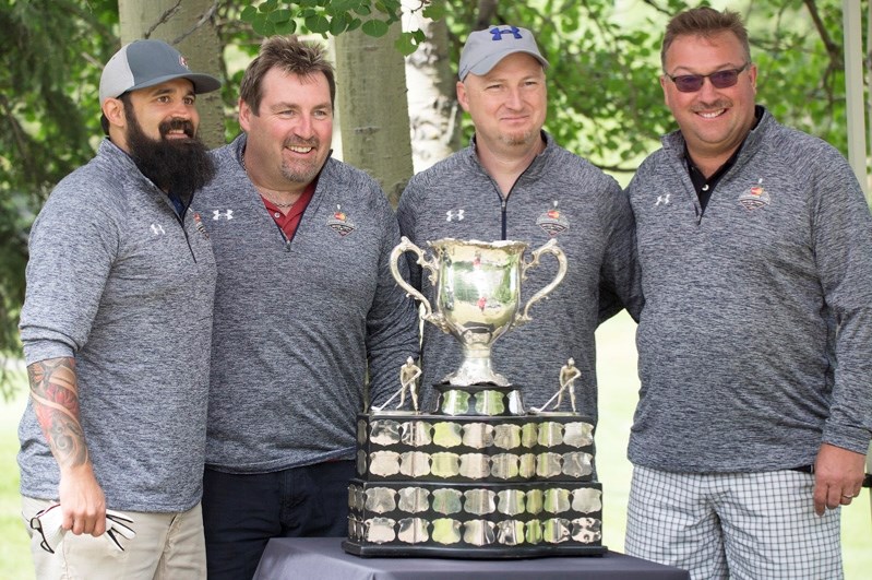 The star of the 2016 Mastercard Memorial Cup Golf Tournament was the actual storied trophy and participants were eager to see it. From left, Ro Mehta, Neil Woelfle, Gord Coy