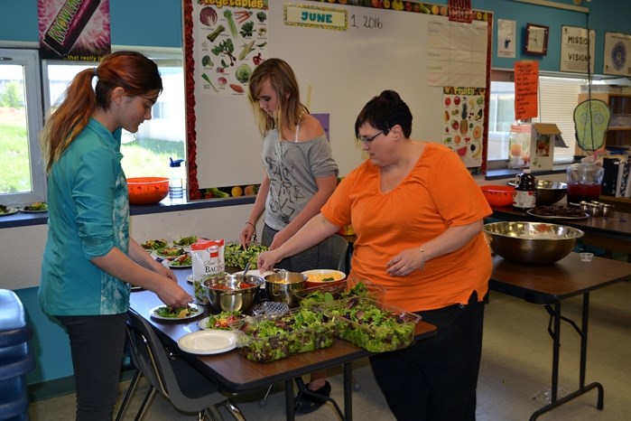 Final preparations underway for the big meal for residents at Autumn Glen lodge for the first ever Seniors Appreciation Dinner at Innisfail Middle School on May 31.