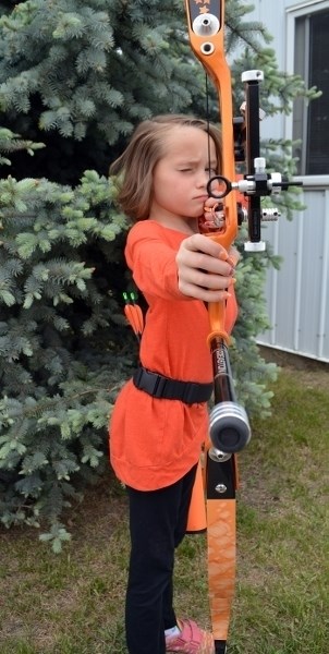 Innisfail archer Arianna Anderson practises her aim with her recurve bow. The young archer recently won a gold and bronze medal at provincial and regional (Canada-wide)