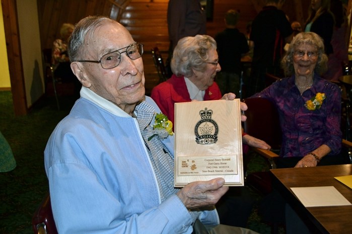 Henry Howard holds a special plaque of a replica of a commemorative brick that is now on permanent display at the Juno Beach Museum in France. The brick has an inscription of 