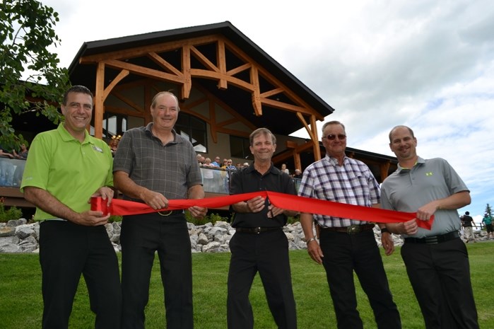 The official ribbon-cutting moment on June 12 to open the brand new $1.9-million clubhouse at the Innisfail Golf Club. From left to right is Tim Pols, the club&#8217;s food