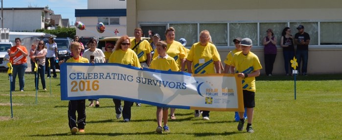 Cancer survivors begin the 2016 Innisfail Relay For Life with the survivors&#8217; lap around the track at Innisfail High School on June 18.