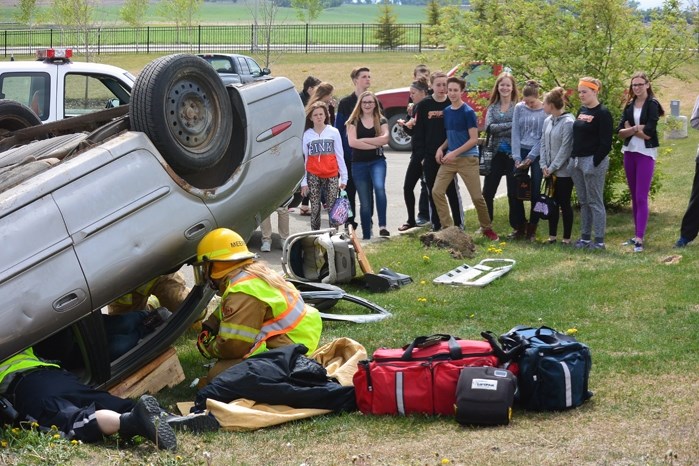 Emergency responders demonstrating the frantic but controlled efforts they make during a life-and-death scenario they face at many motor vehicle accidents, including ones