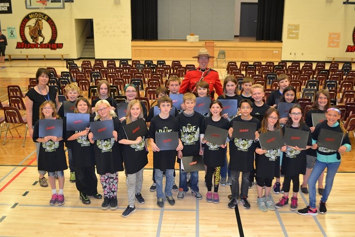 Innisfail Middle School teacher Erin Machell with her Grade 5 class. The students, along with those from two other classes, graduated their eight-week D.A.R.E. program on May 