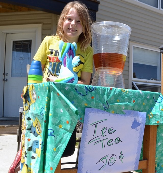 School may be out but business is on the mind of eight-year-old Katie Hughes. She does her best to be a young entrepreneur by setting up an ice tea stand near her home along