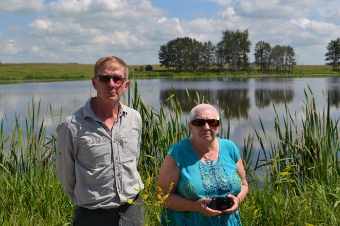 Richard Wagers and Bernice Stewart in front of the still waters of Cook Lake where they say thousands of migratory birds will be threatened with the planned construction of a 