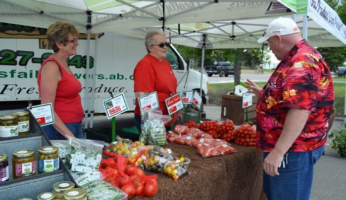 Members of the Innisfail Growers, seen here at the Innisfail Producers&#8217; Market, will be presenting the Feast In the Field fundraiser on Aug. 19 at the Jungle Farm.