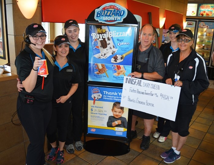 Mark Kemball, owner of the Innisfail Dairy Queen, centre, joins his workers in celebrating $14,000 raised by the Innisfail community for Miracle Treat Day on Aug. 11. All