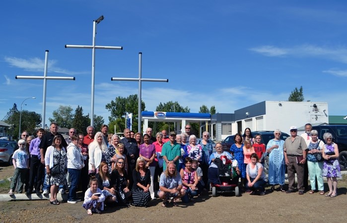 Members of the Penhold Community Church gather on Aug. 14 following a dedication service for its new Three Cross Monument.