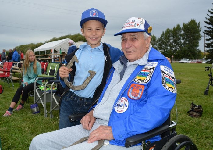 Wade Mountain, 10, left, is continuing the family tradition of playing horseshoes, once played by his great-grandfather Dick Mountain, right, who was honoured at this