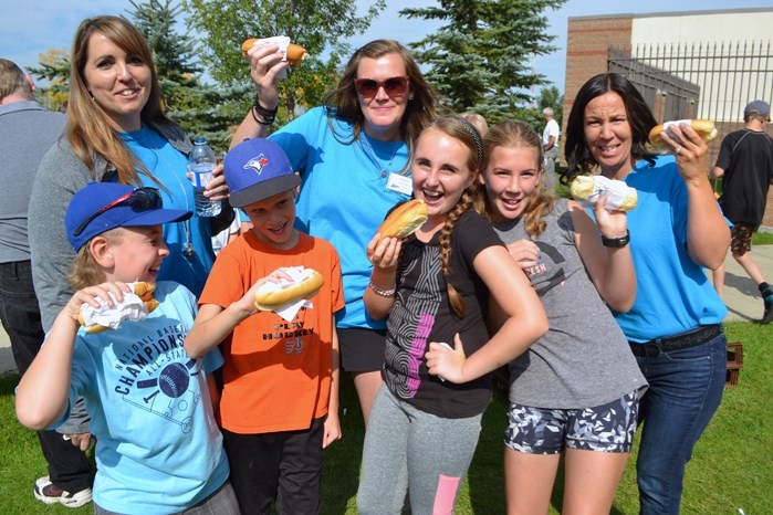 Staff and children ham it up at the Innisfail Schools Campus&#8217;s Welcome Back Barbecue on Aug. 31 with smiles and hotdogs to mark the beginning of the new school year.