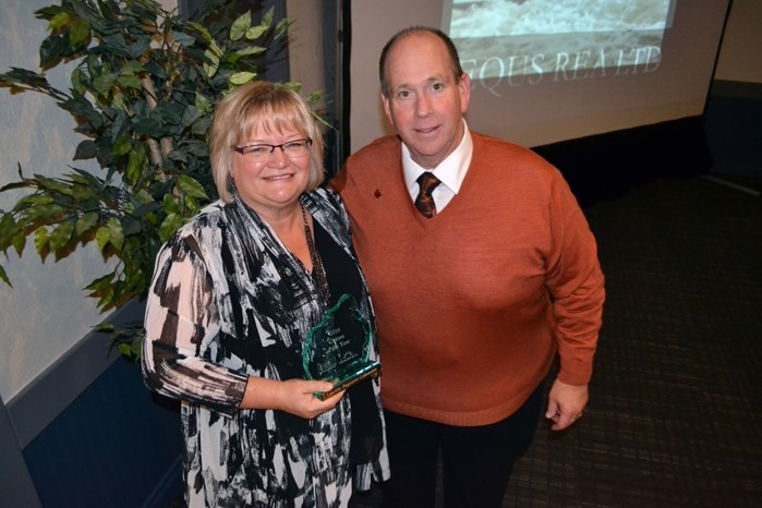 Lucille Paquette-Lohmann, longtime case worker for Big Brothers Big Sisters of Prairies to Peaks, with her Citizen of the Year Award, as Mark Kemball, who MCed the Oct. 14