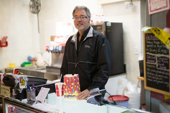 Derek Austin behind the concession at the Century Theatre in Innisfail on Oct. 12. The small business owner is lowering admission prices as a strategy to thrive in the