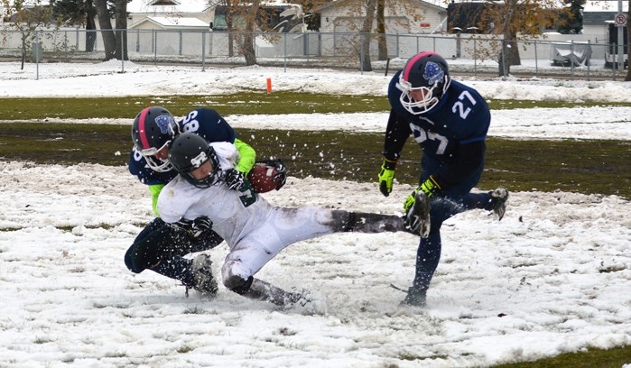 The Innisfail Cyclones take down a Bowden Blazers player en route to an 82 to 6 victory during their last regular season game on Oct. 15 in Innisfail. Playoffs begin Oct. 29.