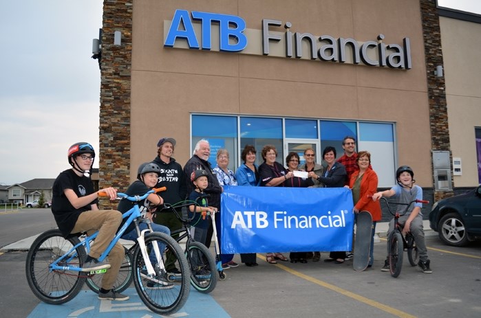 Members of the Penhold and District Optimist Club and Penhold Skatepark Committee joined other community members recently for a $500 donation from ATB Financial.