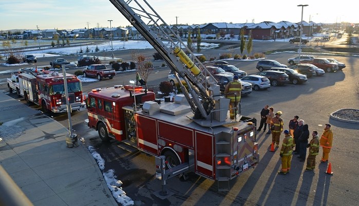 Penhold firefighters demonstrate their new ladder truck for members of council during a council meeting on Oct. 11.