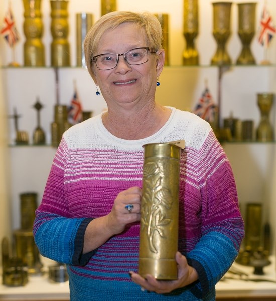 Didsbury Museum manager Dean Mousseau holds a finely crafted and decorated shell casing, part of the facility&#8217;s &quot;Trench Art&quot; collection display.