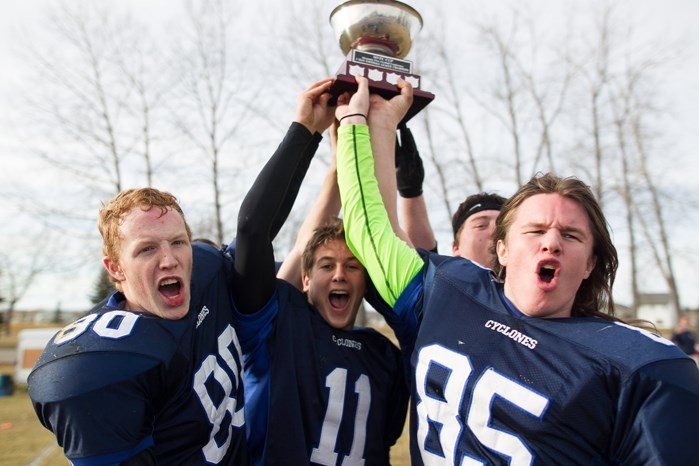 Innisfail Cyclones&#8217; (from left) Jacob Stauffer, Justin Woodruff and Drake Caron hold the Mountain View 9 Man Football Conference championship trophy.