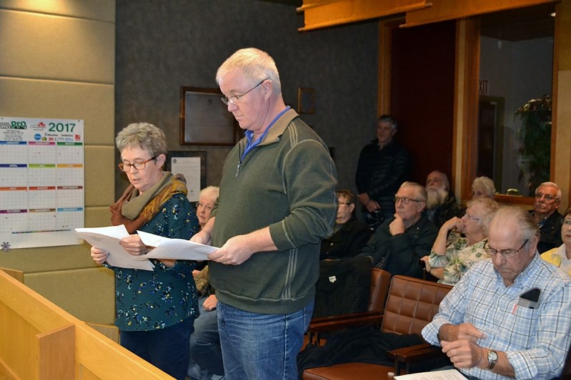 Mary Flemming and Jim Carroll read a three-page letter to town council on Nov. 28. The letter demanded answers to 14 questions about the firings of the town&#8217;s last two