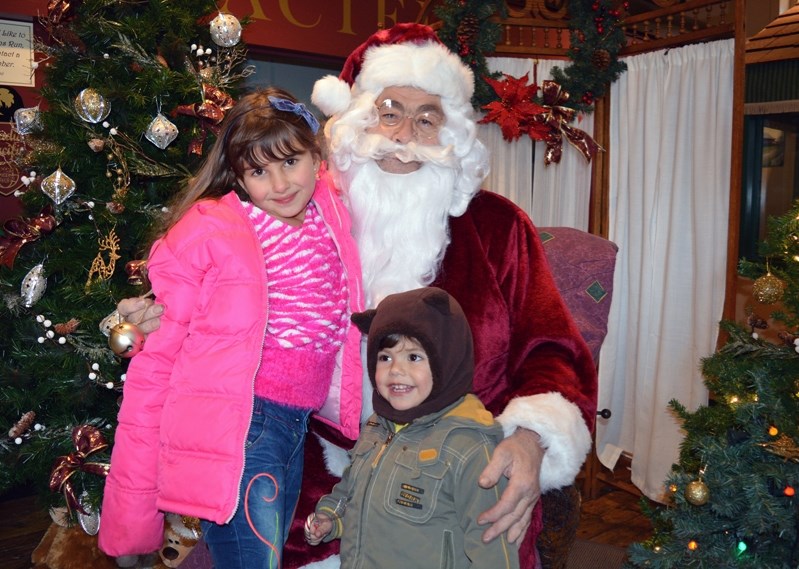 Etwal and her brother Antounyo Kahwate, from Syria, are celebrating their first Christmas in Canada. They met Santa Claus during Christmas at the Village last Saturday at the 