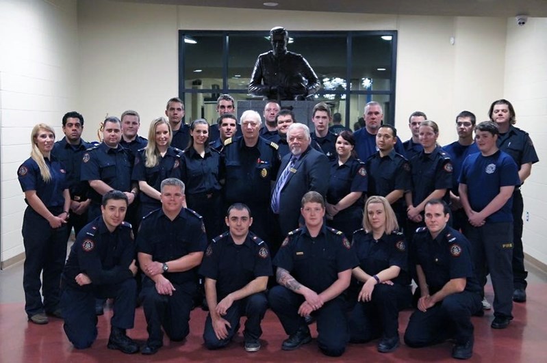 Penhold firefighters gather around fire Chief Jim Pendergast and Mayor Dennis Cooper. They will be playing against the Bowden Institution Correctional Officers team on Dec. 9.